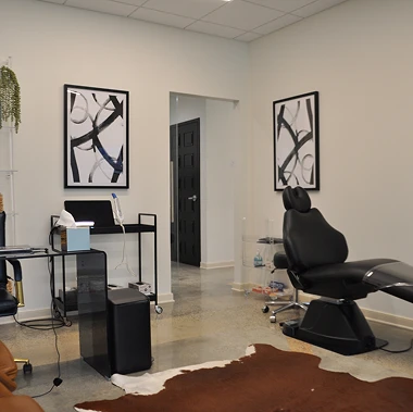 Private treatment room at Pappas Orthodontics with dental chair, abstract artwork, and sleek decor.